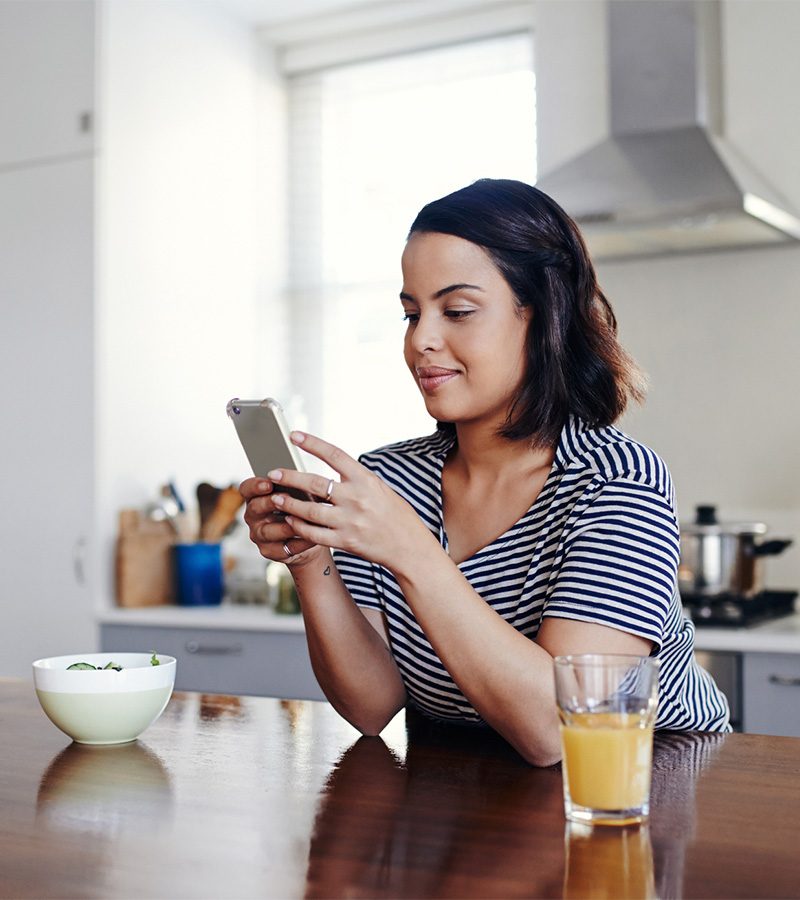 woman-reading-faqs-on-phone-800x900